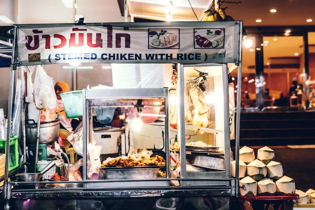 A Bangkok street food cart selling chicken and rice
